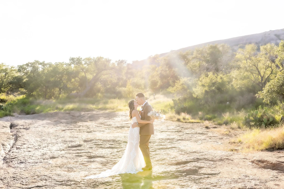 A couple at sunset among the sweeping hills of Enchanted Rock.