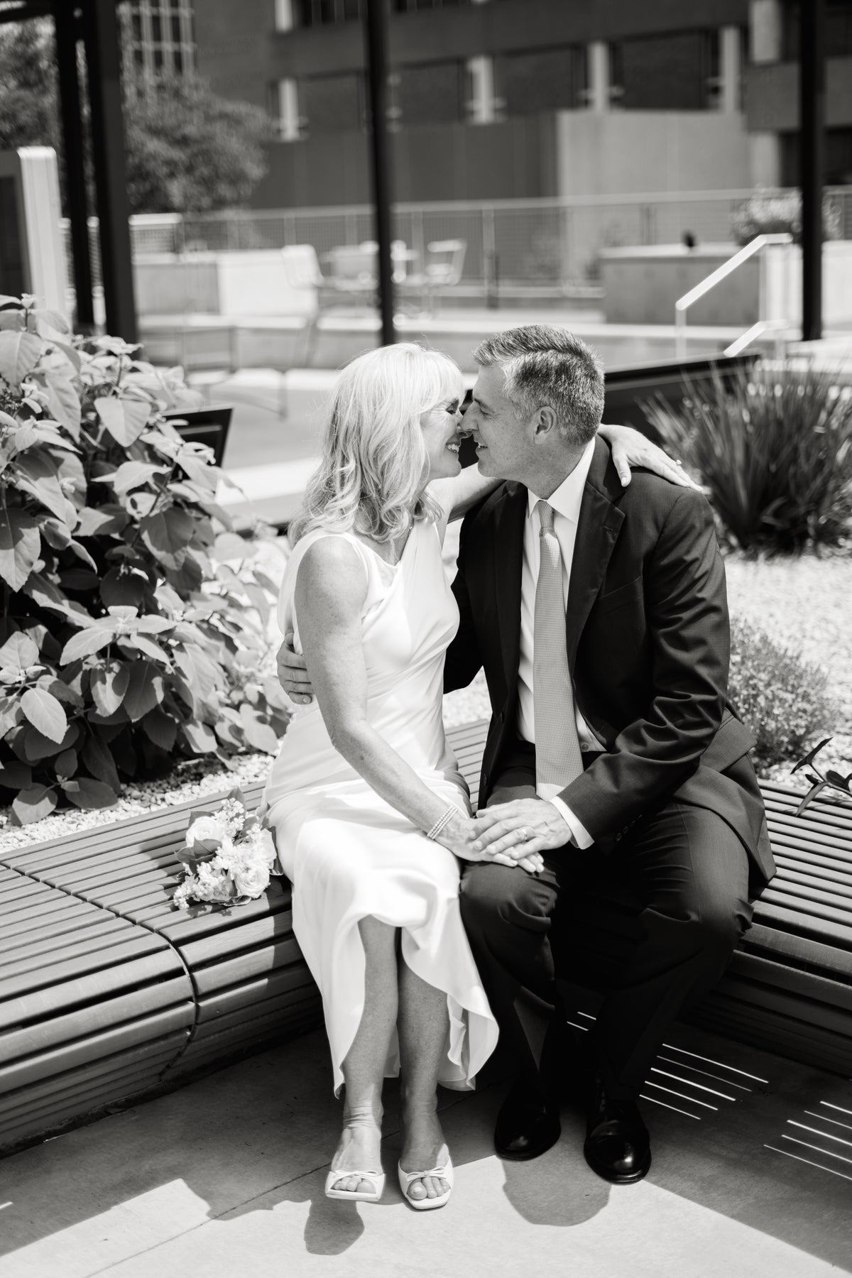 A newlywed couple sharing a quiet moment at Butler Park.