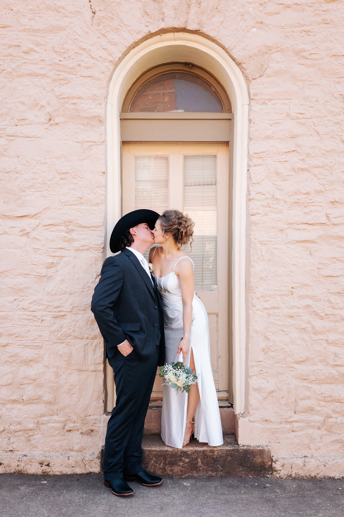 A newlywed couple kissing outside Chapel Dulcinea.