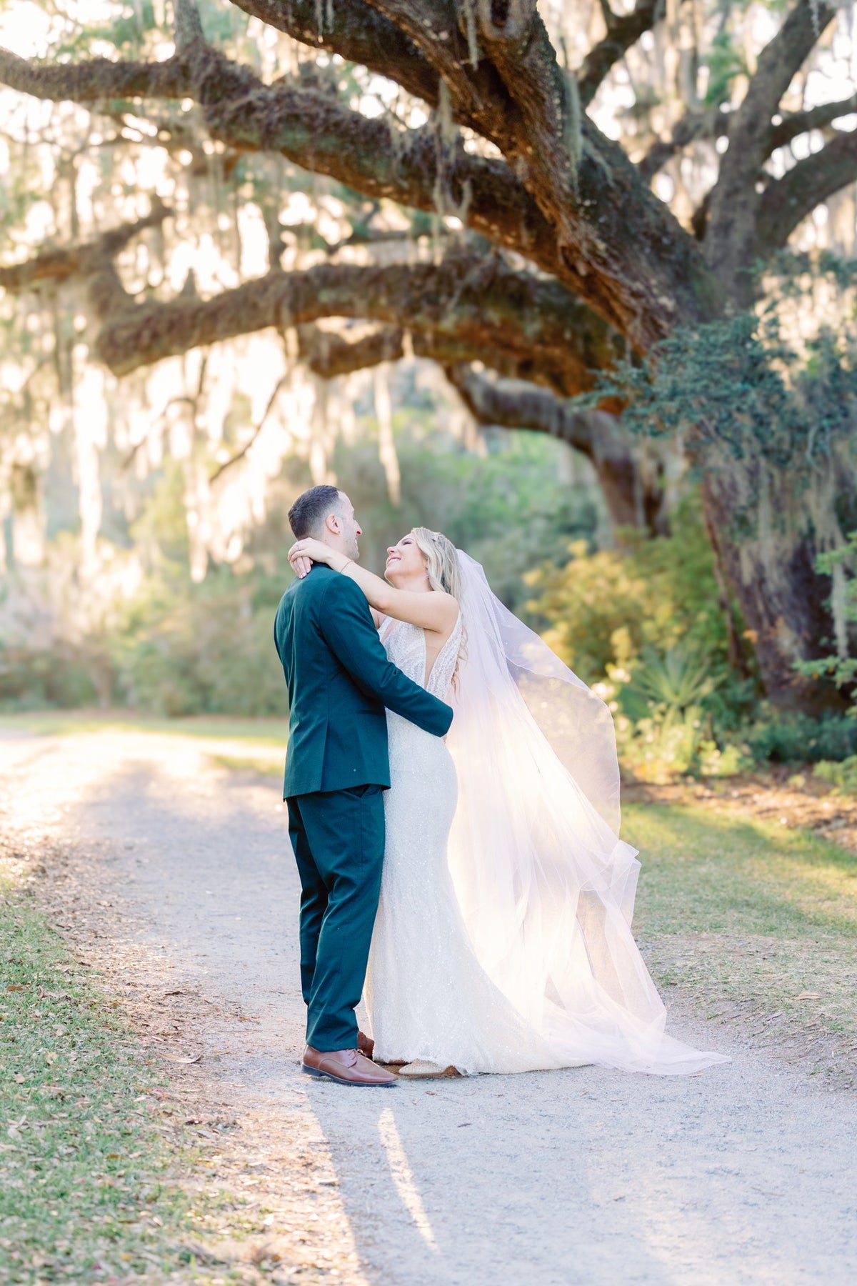A couple beneath a spreading oak in Charleston. Jolie Connor Photography.