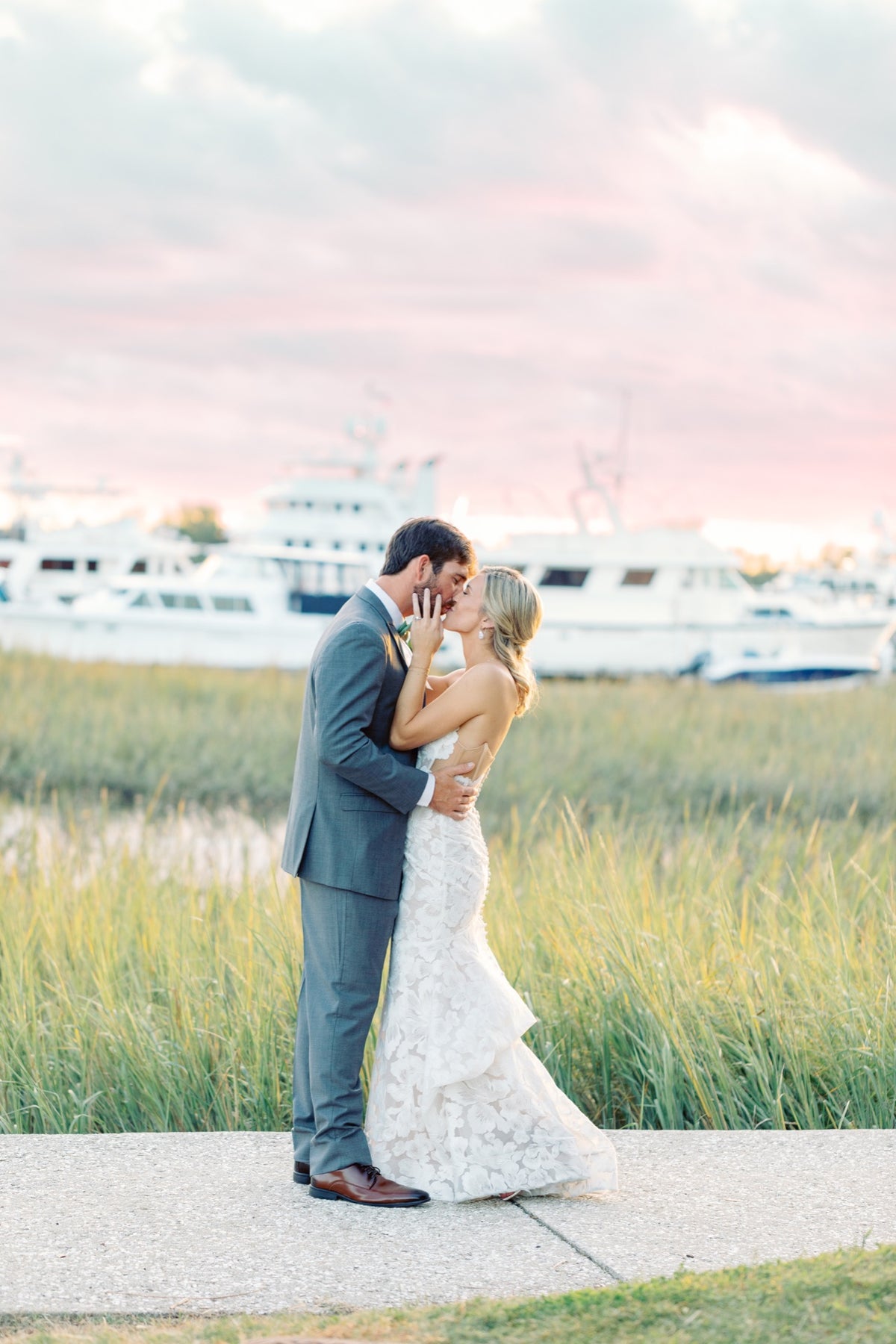 A couple beside the Charleston waterfront. Jolie Connor Photography.