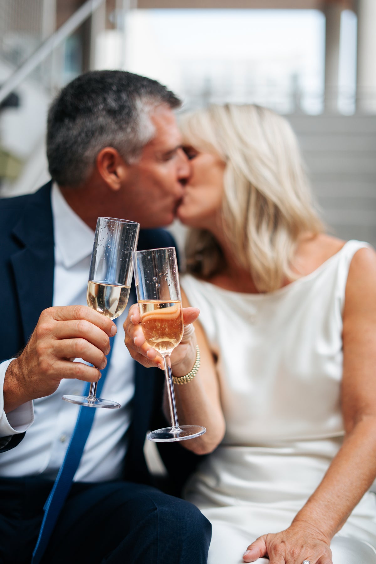A newlywed couple toasting after their ceremony.