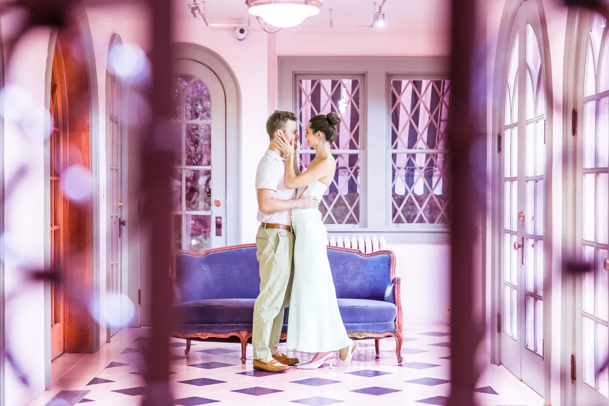 A couple together in a pink room at Laguna Gloria.