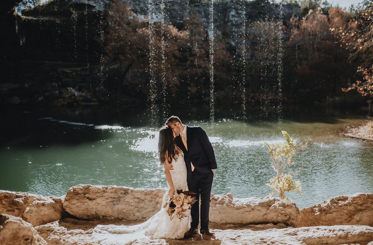 A wedding moment beside the water at Hamilton Pool Preserve.
