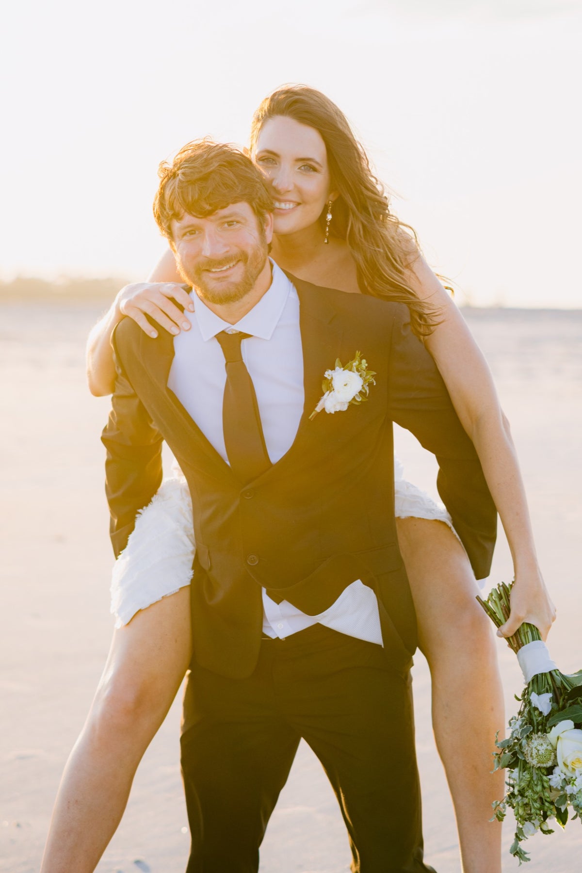 A couple on the beach at Tybee Island in warm evening light. Photography: Josh Stewart Photography.
