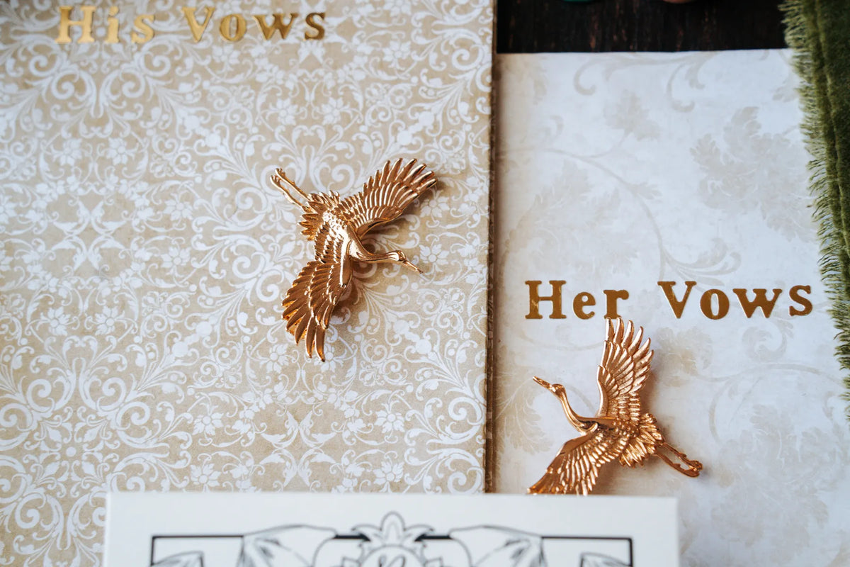 Vow books with decorative gold details.